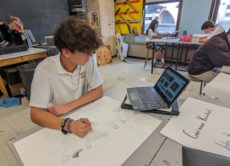 Student using new laptop to assist in his art project