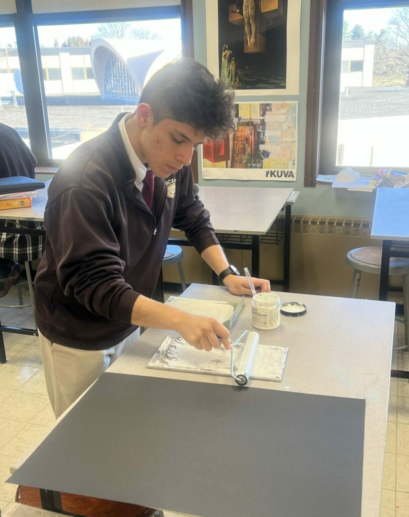 image of Bethlehem High School student working on his project in Art class