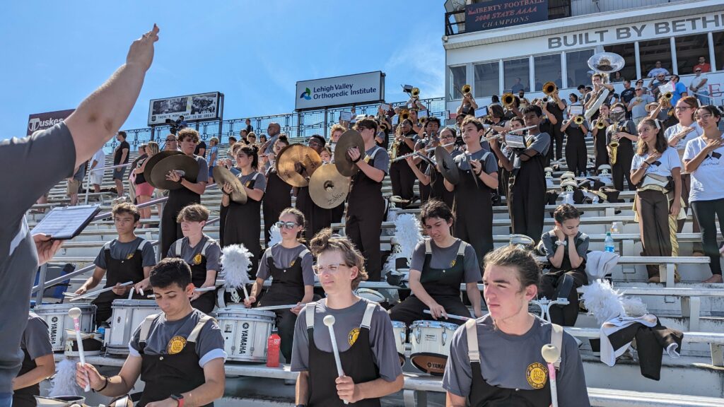 Bethlehem Catholic Marching Band playing in stands during a football game.